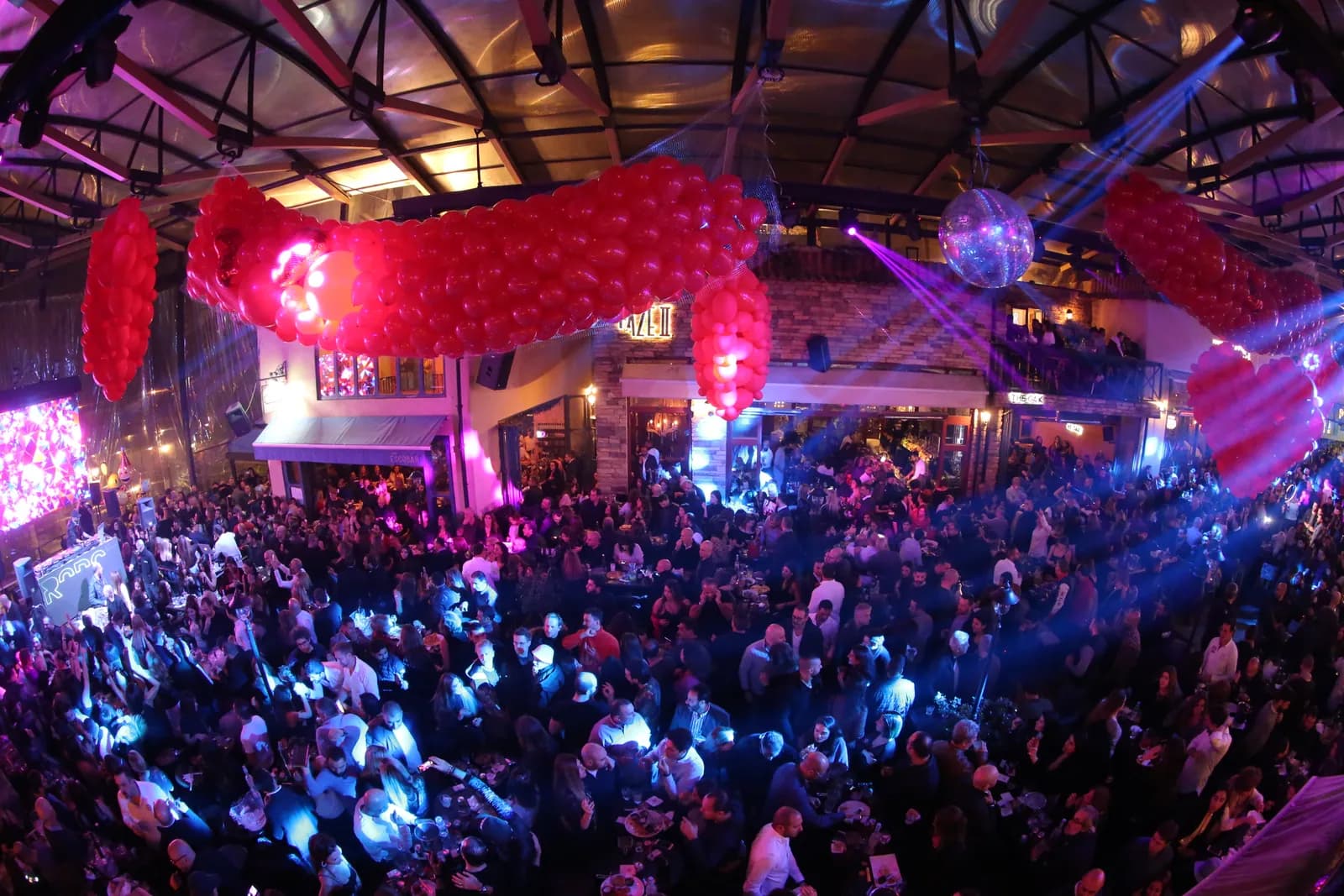 Crowd at a live event with full stage sound and lighting